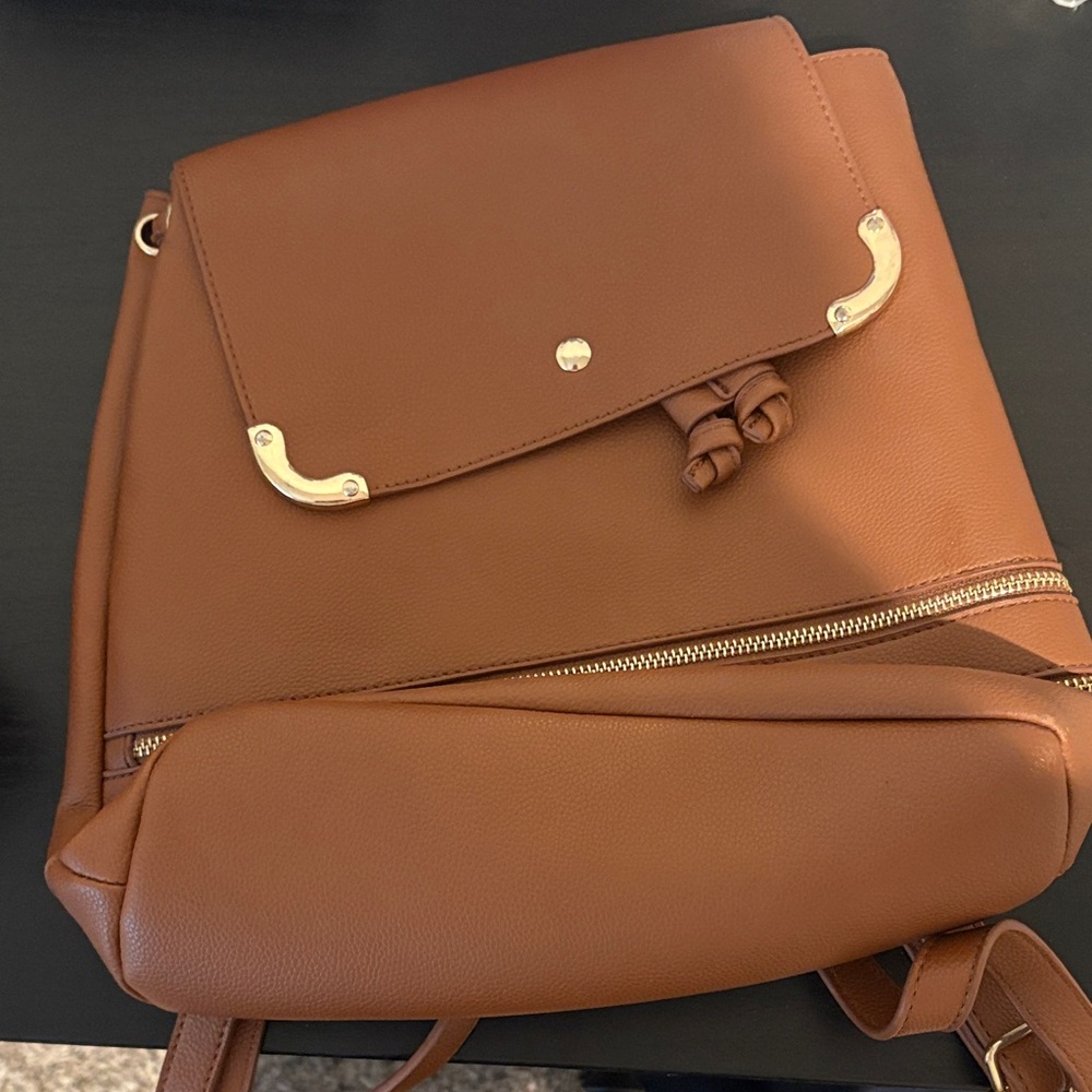 chic brown leather backpack with gold accents